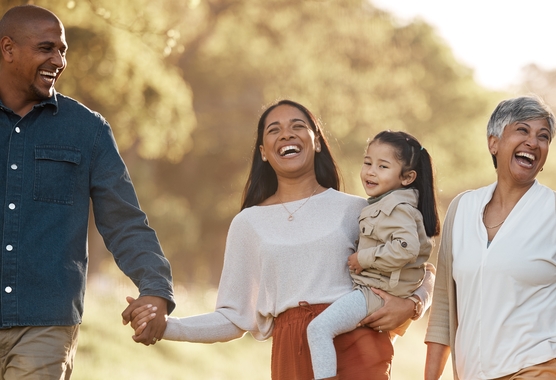 A family walks together and smiles.