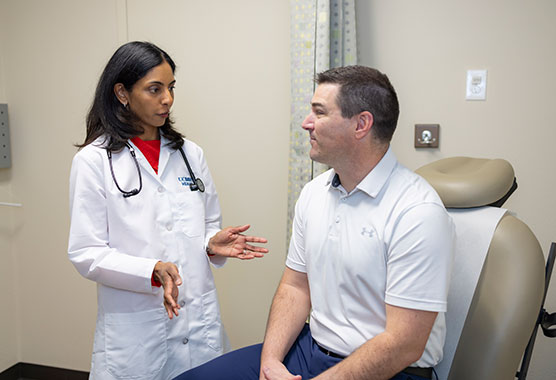 Female nurse talking to male patient in the clinic