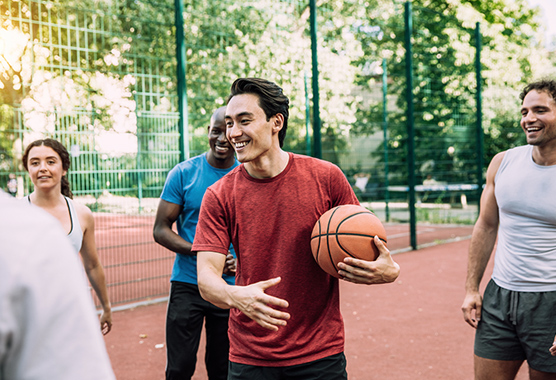 People playing basketball in a city park.