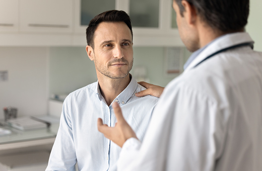 Health care provider talking to male patient before urodynamic testing.