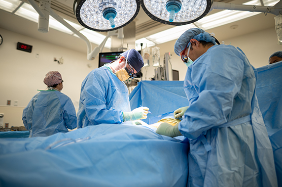 Surgeons performing surgery on a transplant patient