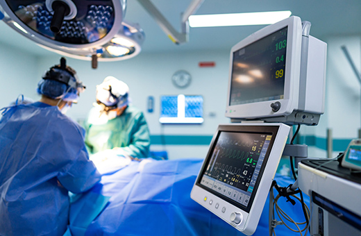 Surgeons performing burn surgery on patient in hospital.