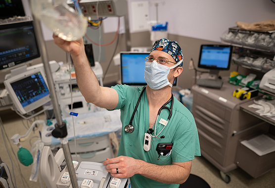 Male anesthesiologist in the operating room