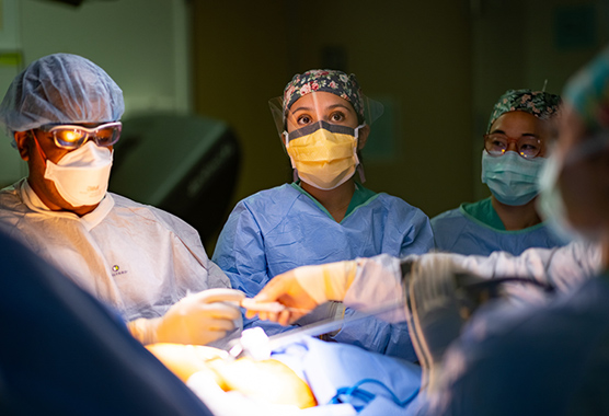 Surgeon performing esophagectomy in operating room.