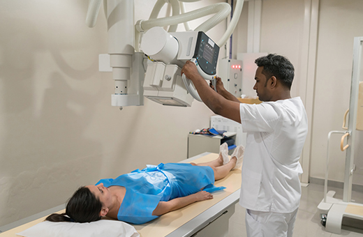 Woman getting x-ray to find gallstones.