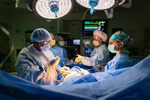 Surgical staff operating on a heart patient in the operating room