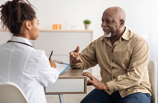 A patient and nurse talk in an office. 