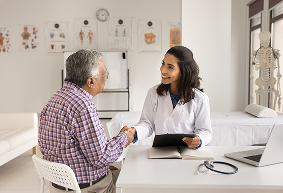 Male patient speaking to urologist about prostatectomy.