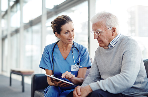 A therapist discusses care options with an elder patient.