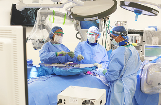 Spine surgeons performing spine neurosurgery on patient.