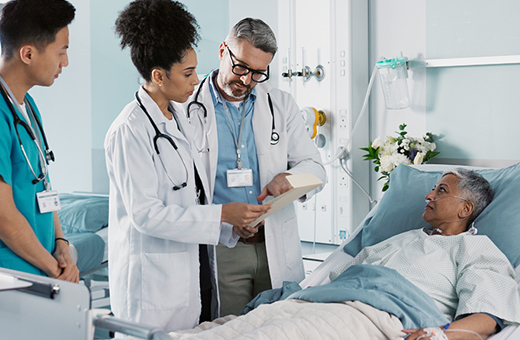 Health care providers talking to patient after thoracic surgery.