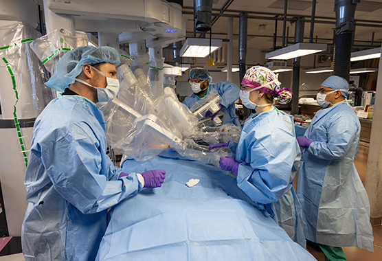 Surgeons using robotic surgery on vascular surgery patient.