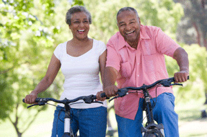 Male and female riding bikes