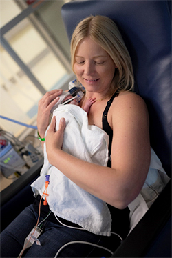 Katherine Marlin holding her baby Cade who was born preterm. Cade has higher protein needs in his diet, so he got protein-fortified breast milk.
