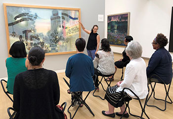 Image of audience looking at art in a museum