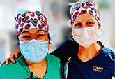 The energetic scrub hats donated from Protect with Heart brought smiles to ICU nurses Kristina Balneg (left) and Jocelyn Spiwak (right).