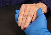 patient holding hand of medical person
