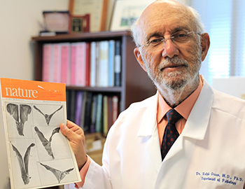Ralph Green holds a copy of his study demonstrating that B12 deficiency causes significant neurologic changes in bats.