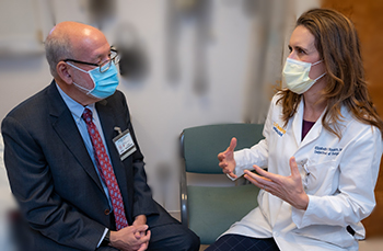 UC Davis epidemiologist Brad Pollock meets with his colleague and cancer surgeon Elizabeth Raskin during post-op visit.