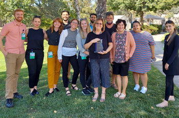 VOA Services Coordinator Pamela Galloway, center, and nursing students who worked with senior residents. (Photo taken before current COVID-19 rules.)