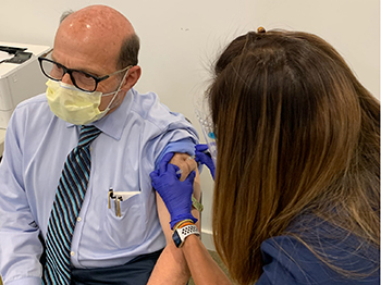 Chief of Infectious Diseases Stuart Cohen receives Pfizer booster shot. First shots went to Emergency Department, ICU and Infectious Disease workers.