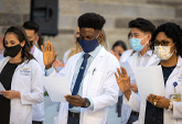 Physician assistant students recite their oath