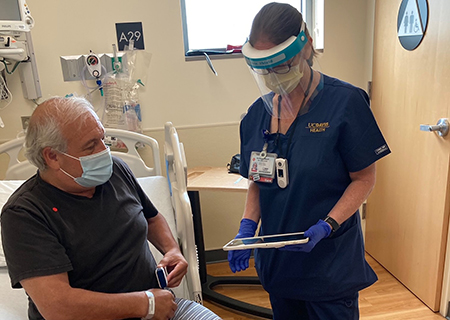 Cancer patient Peter Romero gets instructions from infusion nurse Deborah Small