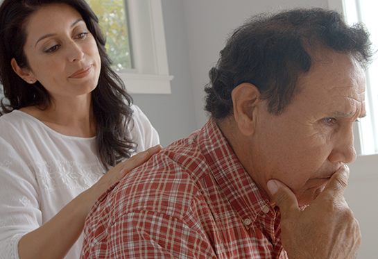 Latina woman caregiver comforting her father