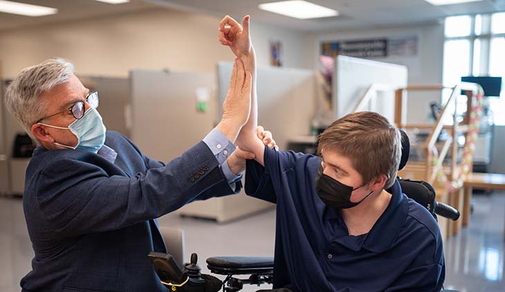Dr. Craig McDonald examining a male child with Duchenne muscular dystrophy