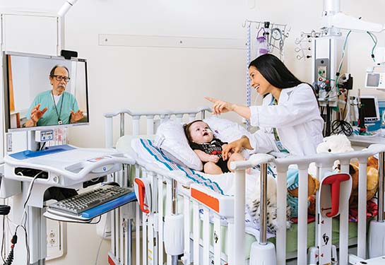 Nurse with pediatric patient speaking with doctor