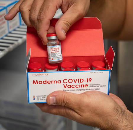 A box filled with vials of the Moderna COVID-19 vaccine.