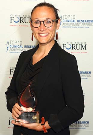 Alicia Agnoli holding the Distinguished Clinical Research Achievement Award