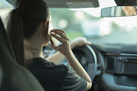 Female using cell phone while driving