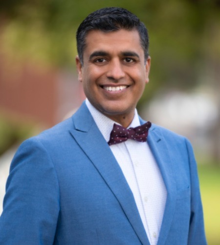 Ashish Atreja wearing a blue jacket and bow tie