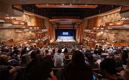 Hundreds of UC Davis School of Medicine friends and family sit inside the Mondavi Center in Davis watching the 2022 commencement ceremony