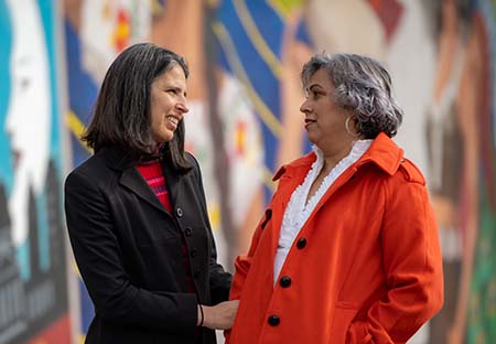 Laura Fejerman hugging promotora Maria Gonzalez  