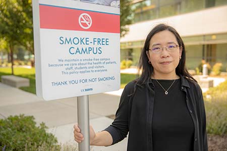 Elisa Tong with campus no smoking sign