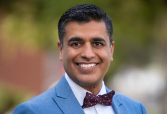Ashish Atreja wearing a blue jacket and bow tie