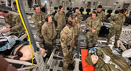 Soldiers on a plane helping a patient