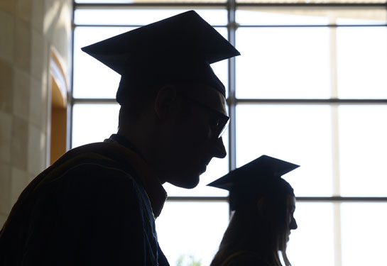 silhouette of graduate wearing cap and gown