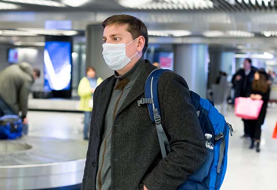 Man in airport wearing a mask