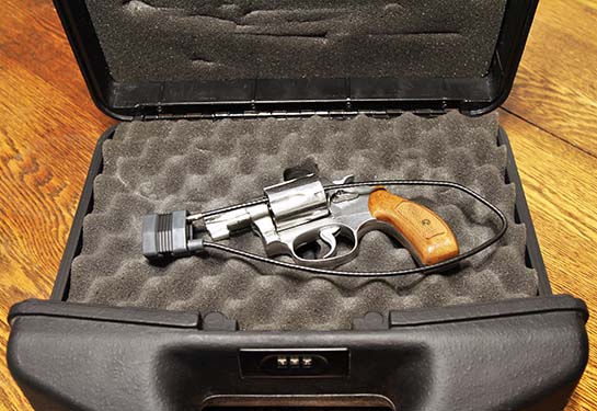 Revolver in lock case with combination lock.  