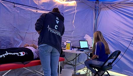 Person receives EKG in medical tent