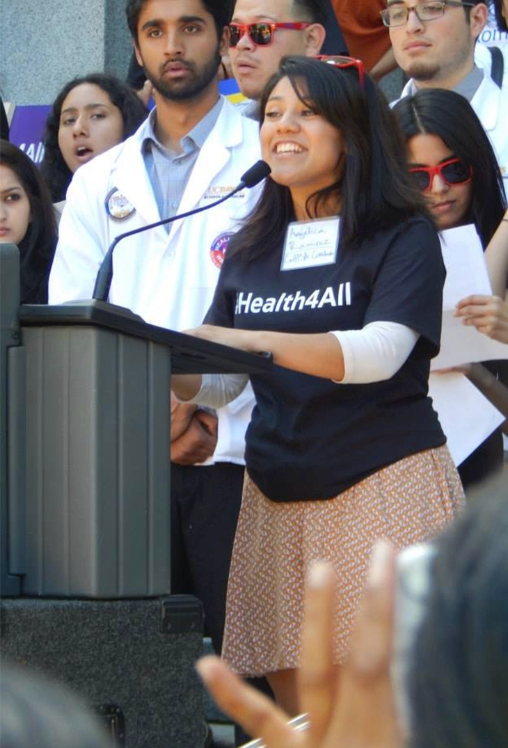 Angelica Martin speaks at the podium microphone during a Health4All rally promoting health care access to every Californian 