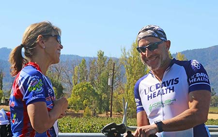 UC Davis Health CEO David Lubarsky and OB/GYN CAO Sherri Stone talking after bike ride  
