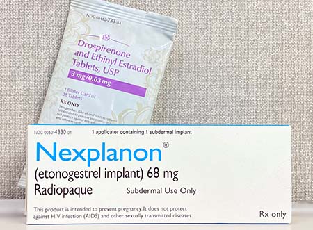 A pack of birth control pills and a Nexplanon implant