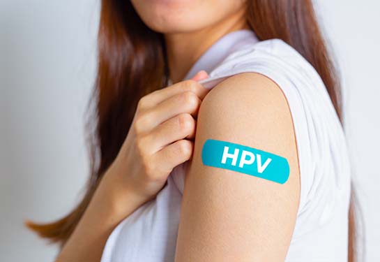 HPV bandaid on a teen's arm
