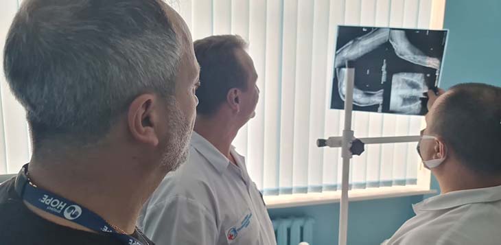 Three doctors looking at x-ray