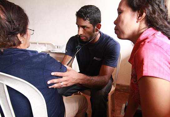Male doctor helping female patients in the Philippines