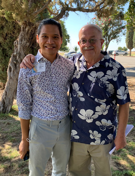 D.N.P. student Allan Dumlao stands next to Marc Grossman who has his hand on Dumlao's shoulder